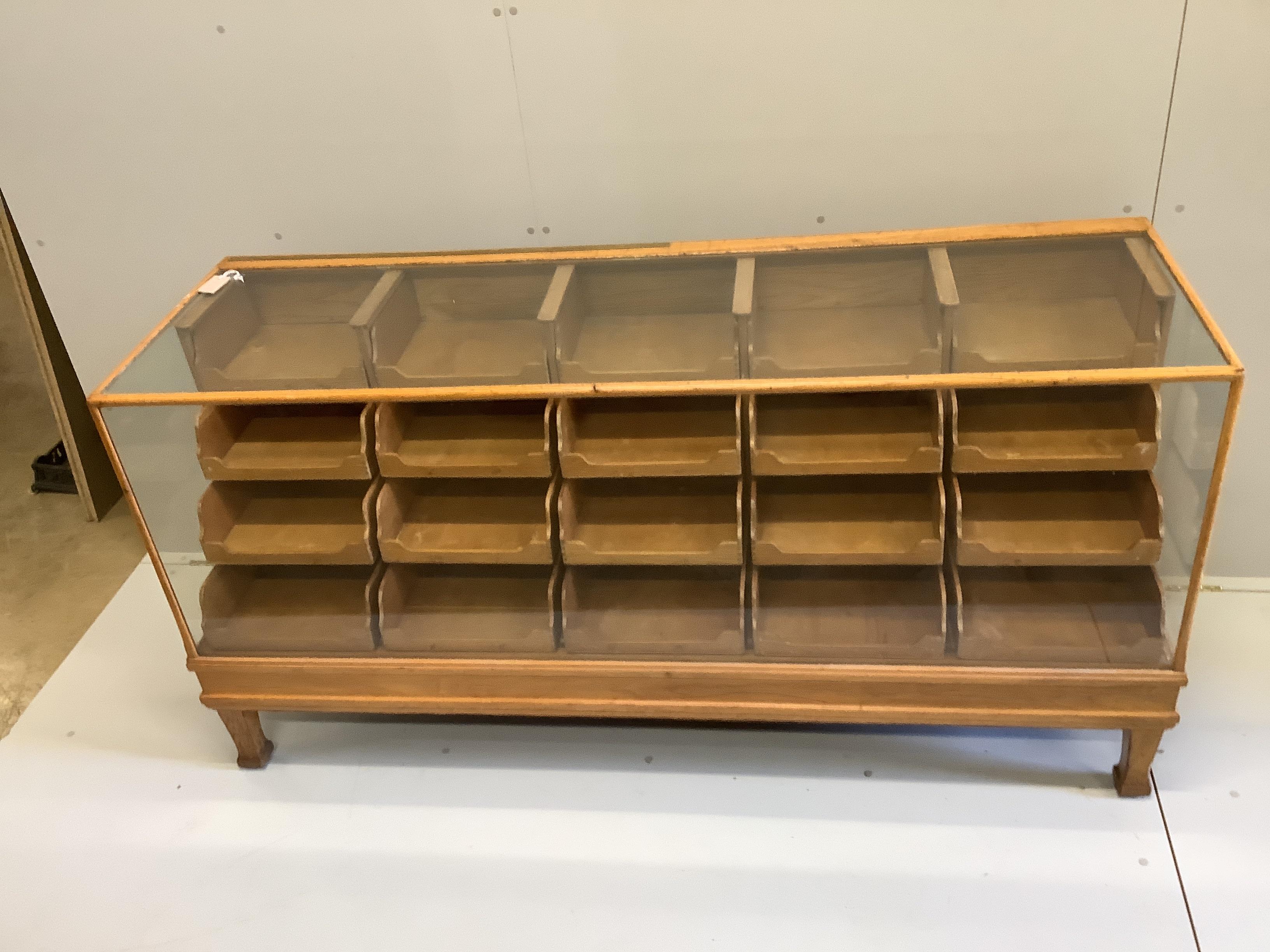 An early 20th century oak haberdashery cabinet, width 180cm, depth 58cm, height 91cm